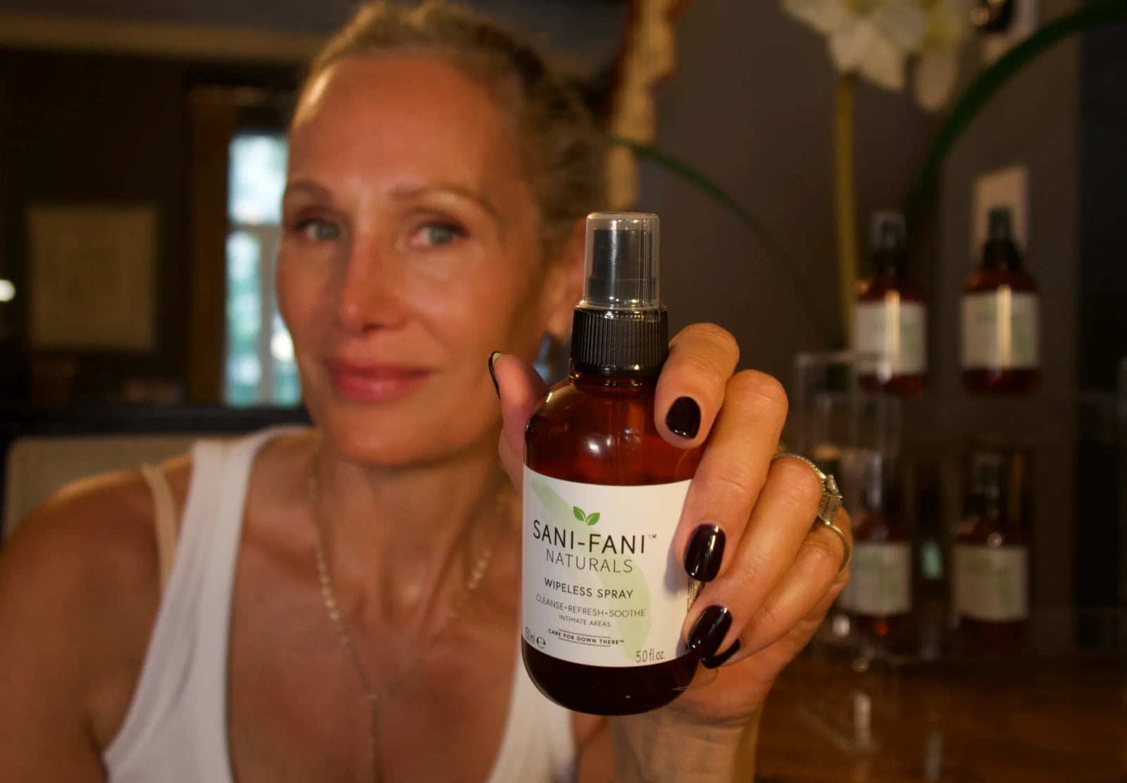 Morgen, founder of Sani-Fani, holding a bottle